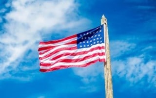 USA Flag Waving in a Beautiful Blue Sky