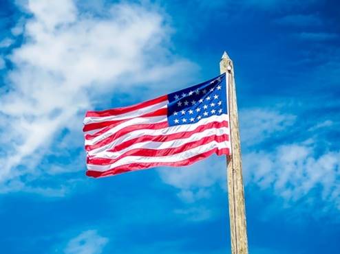 USA Flag Waving in a Beautiful Blue Sky